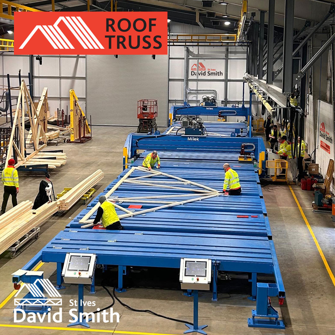 Men working on roof truss in factory