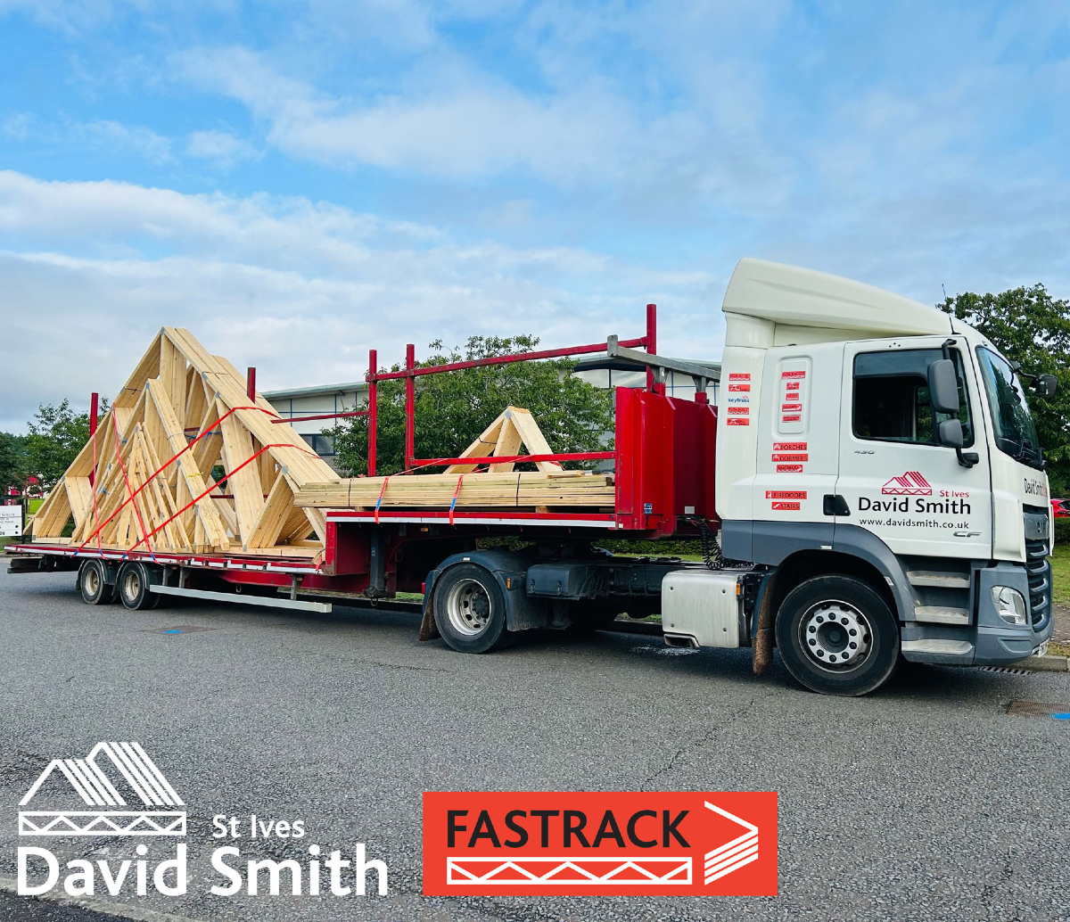 Flat bed lorry with timber roof trusses on back