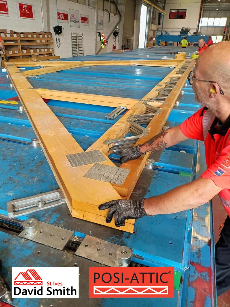 Man working on posi attic truss in factory