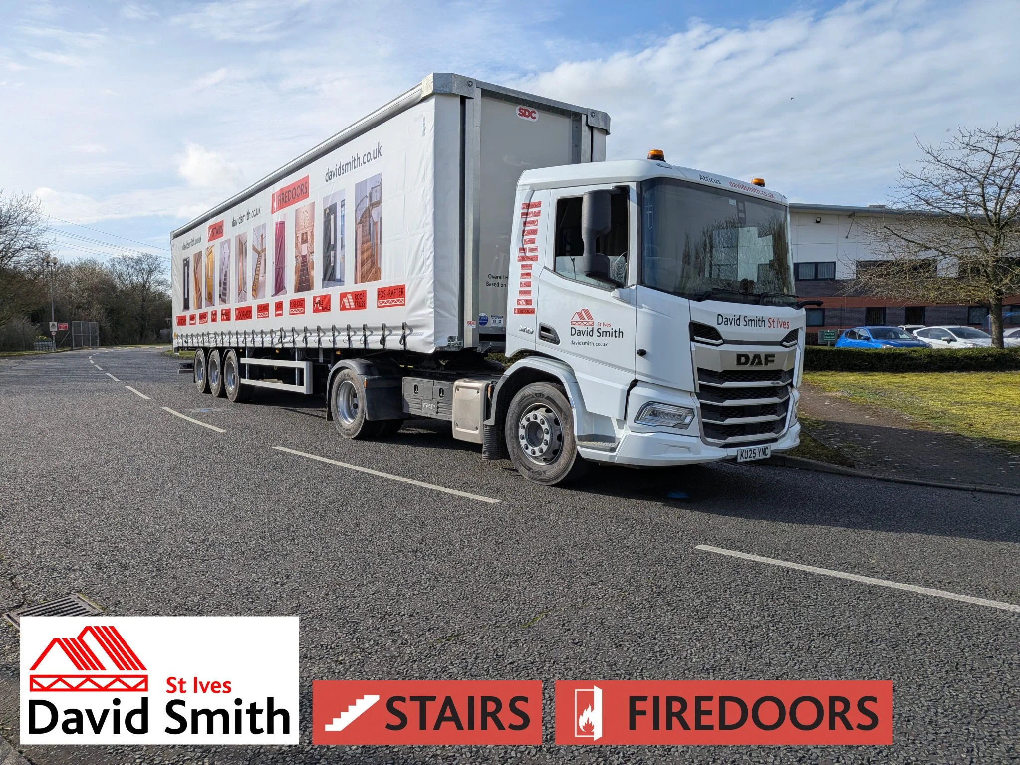 White lorry covered in DSSI imagery and branding on a road on a sunny day.