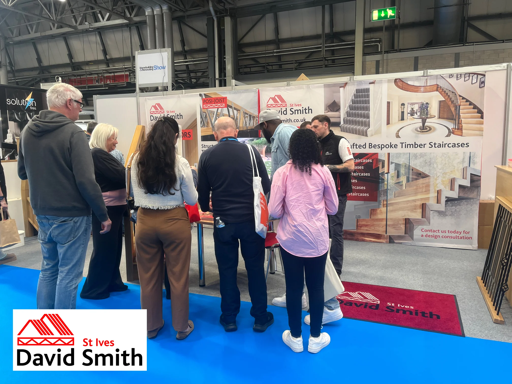 A DSSI stand with people huddling around the stand.