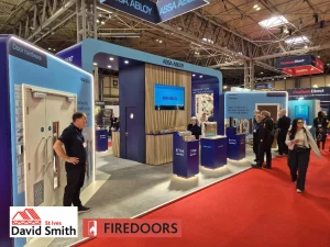 Blue stall in a show with red carpet and people walking around