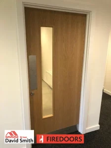 Door with window panel fitted in a room